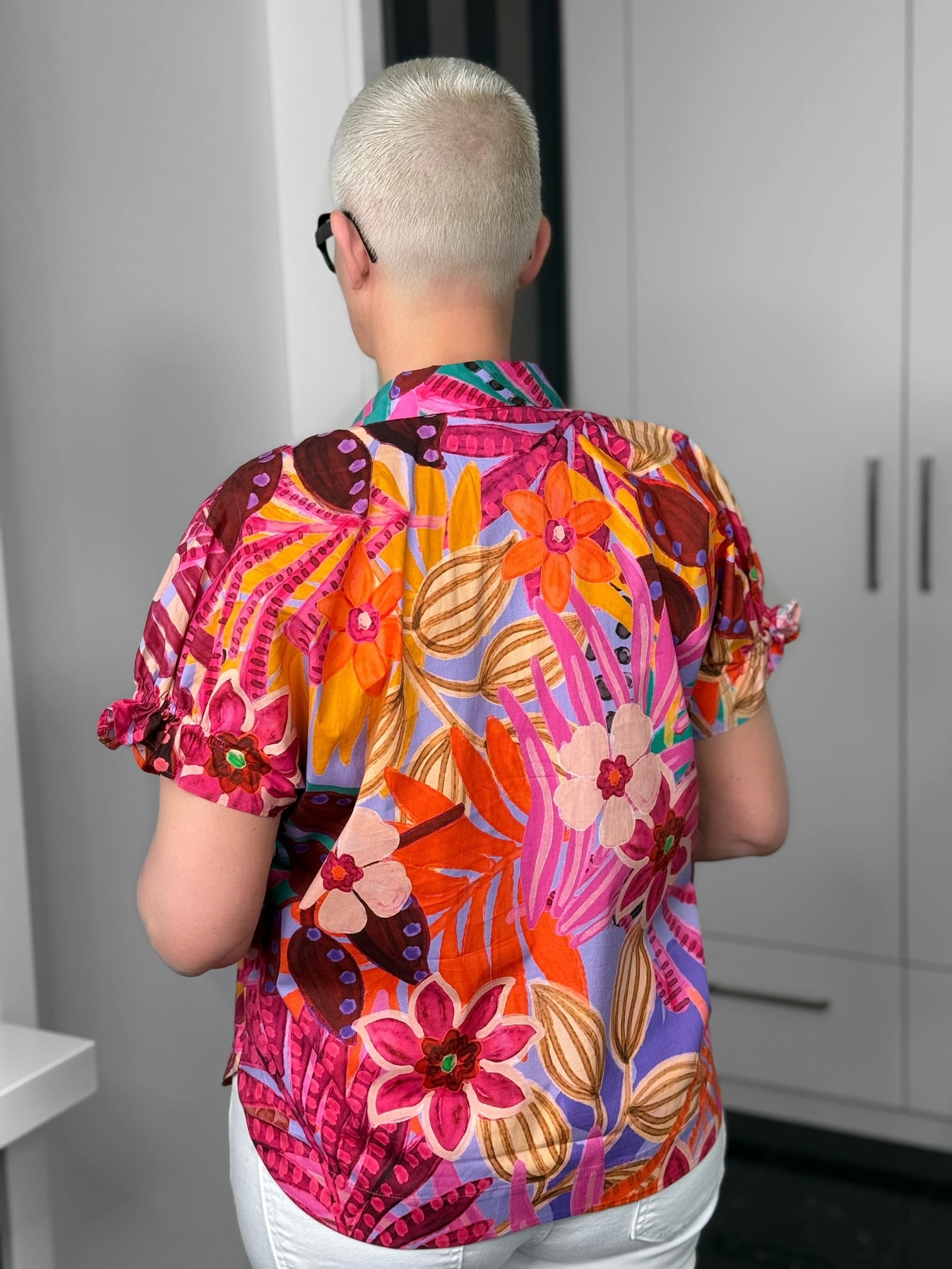 Milano Italy-Bluse-62-2437-6100-1300-6 Person mit buntem Blumenhemd von hinten