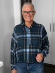Lächelnde Frau mit Kurzhaarschnitt und Brille